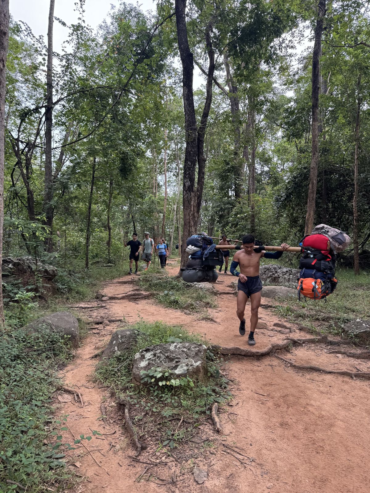 Hikers and porters ascending the trail at Phu Kradueng National Park, Loei Province, Thailand